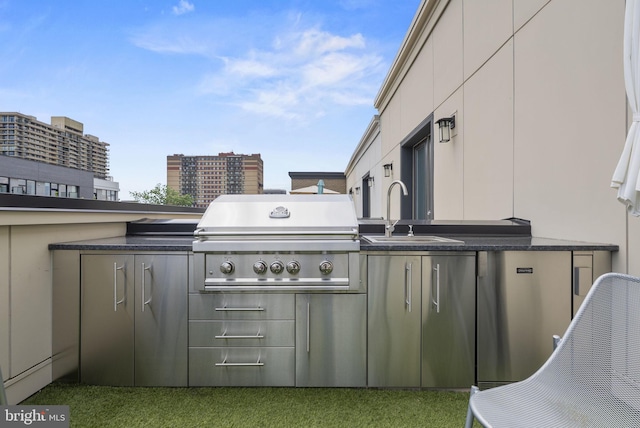 view of patio with an outdoor kitchen, sink, and grilling area