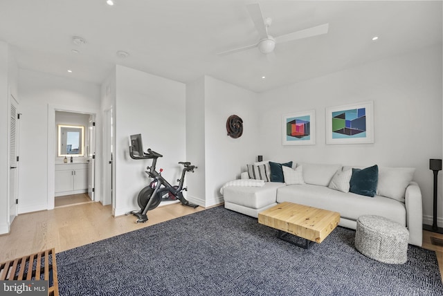 living room featuring ceiling fan and light hardwood / wood-style floors