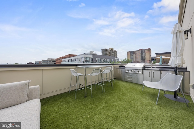 exterior space with an outdoor kitchen, a grill, and sink