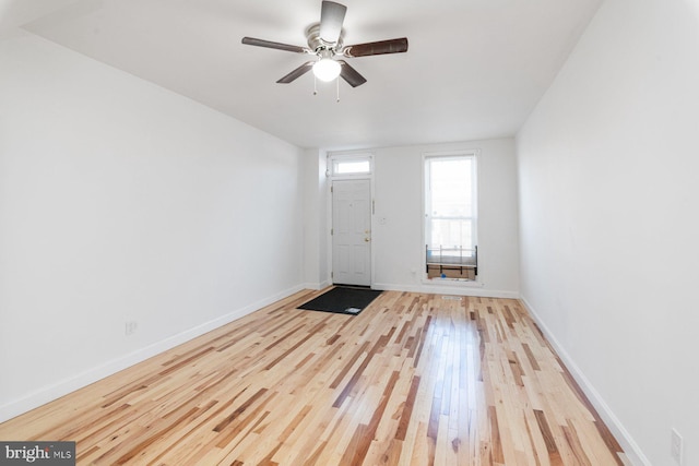 foyer with a ceiling fan, light wood-type flooring, and baseboards