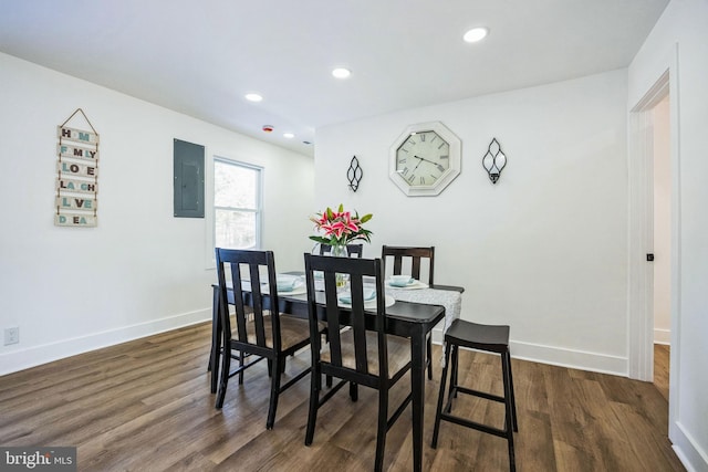 dining space with dark hardwood / wood-style floors and electric panel