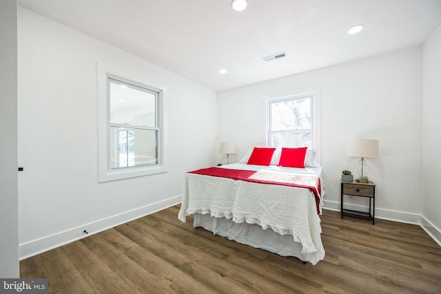 bedroom with dark hardwood / wood-style floors