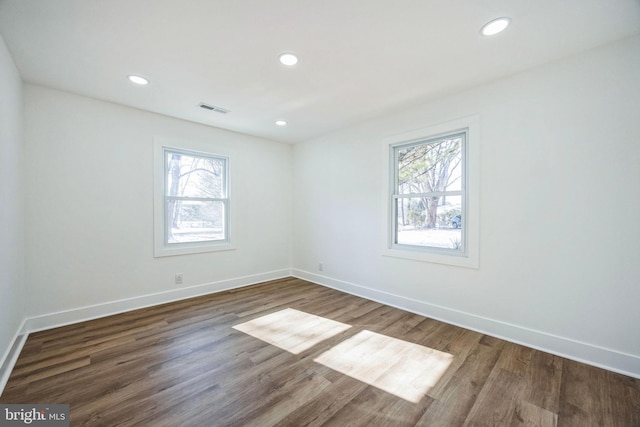 unfurnished room with dark hardwood / wood-style floors