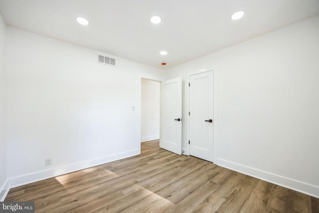 unfurnished room featuring light hardwood / wood-style floors