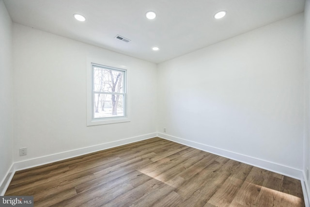 unfurnished room with wood-type flooring