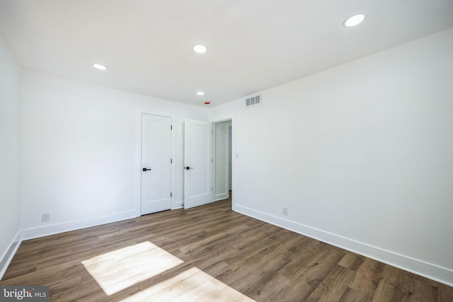 spare room with hardwood / wood-style floors