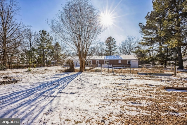 view of snow covered rear of property