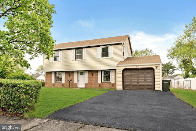 view of front of home with a garage and a front lawn