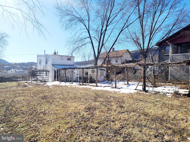 rear view of property with a lawn