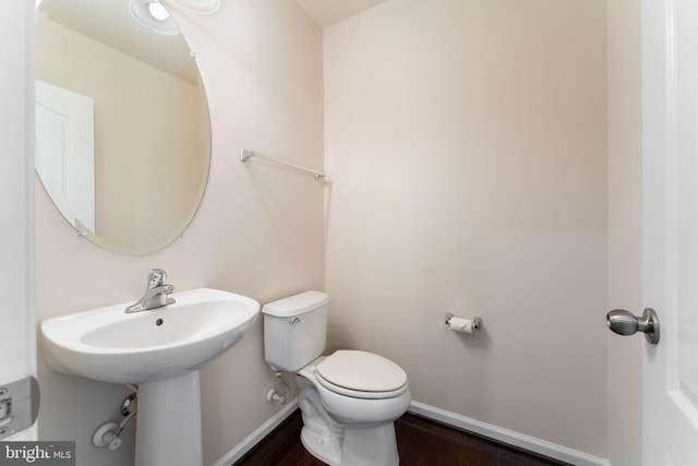 bathroom featuring wood-type flooring and toilet