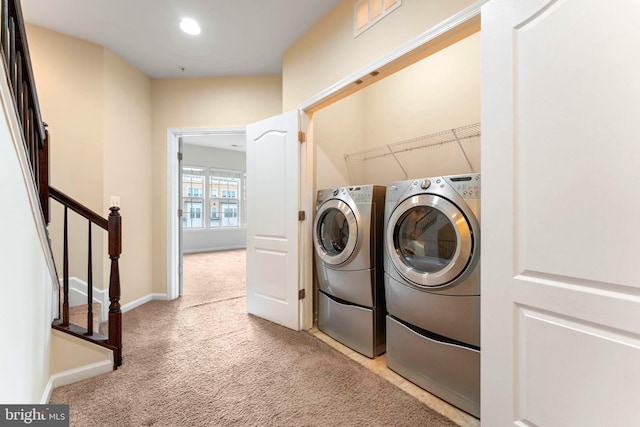 washroom with light carpet and washer and clothes dryer