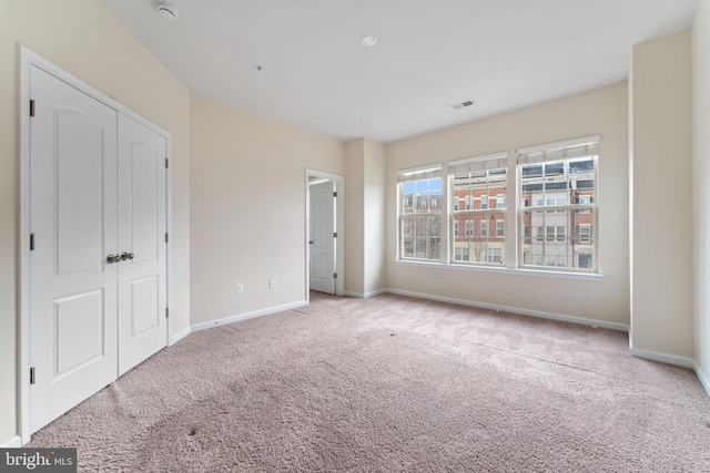 unfurnished bedroom with light carpet