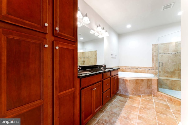 bathroom featuring tile patterned floors, independent shower and bath, and vanity