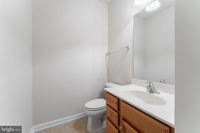 bathroom featuring vanity, tile patterned floors, and toilet