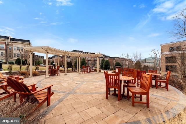 view of patio with a fireplace and a pergola