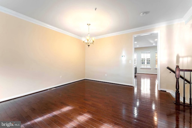 empty room with ornamental molding, dark wood-type flooring, and a chandelier