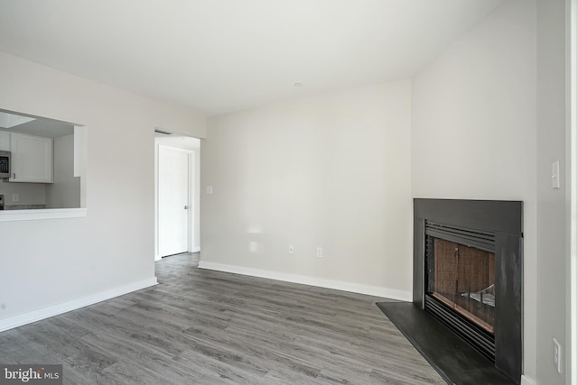 unfurnished living room featuring hardwood / wood-style floors