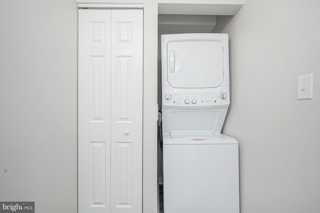 washroom featuring stacked washer and dryer