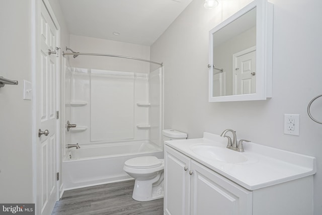 full bathroom with vanity, hardwood / wood-style floors, toilet, and washtub / shower combination