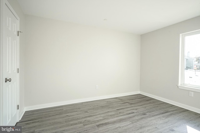 unfurnished room featuring dark hardwood / wood-style flooring