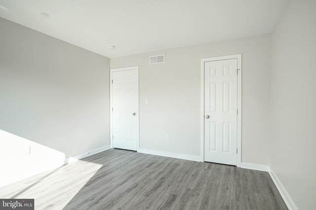 spare room with hardwood / wood-style floors