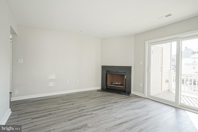 unfurnished living room featuring wood-type flooring