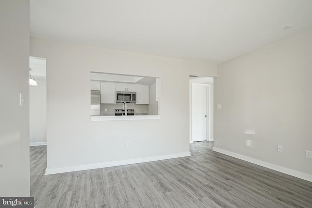 unfurnished living room featuring hardwood / wood-style flooring