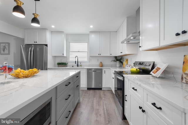 kitchen featuring pendant lighting, appliances with stainless steel finishes, and white cabinets