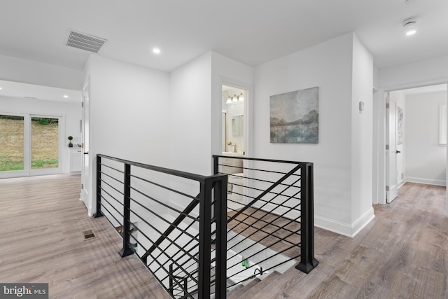 hall with hardwood / wood-style floors