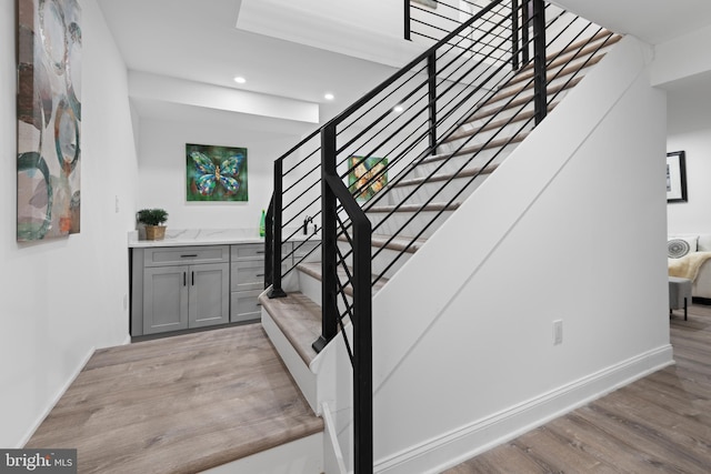 stairs with wood-type flooring