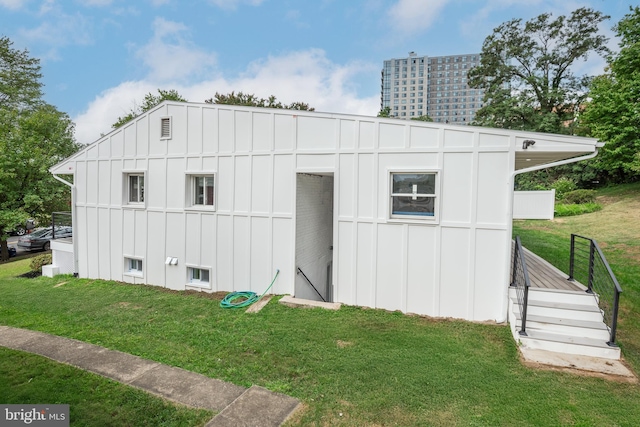 view of outbuilding with a lawn