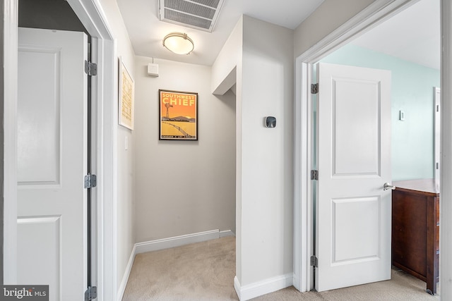 hallway featuring light carpet