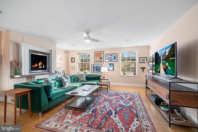 living room featuring ceiling fan and light wood-type flooring