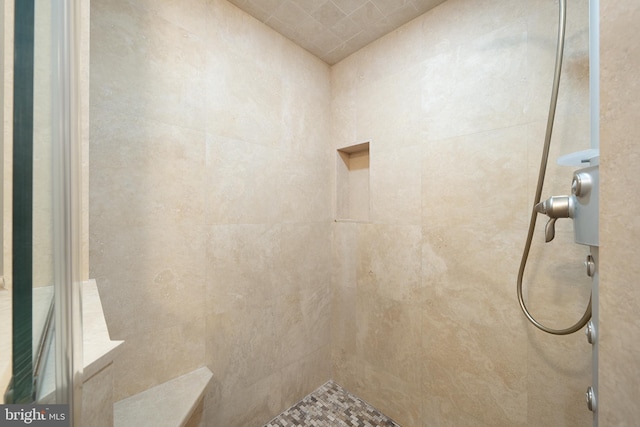 bathroom with tiled shower