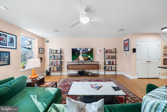 living room with hardwood / wood-style flooring and ceiling fan