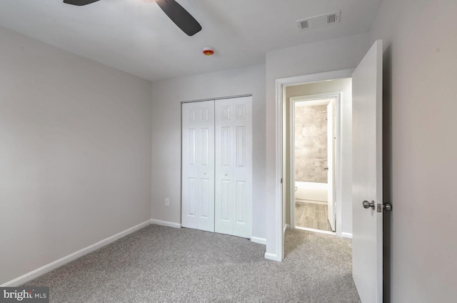 unfurnished bedroom featuring carpet floors, ceiling fan, and a closet