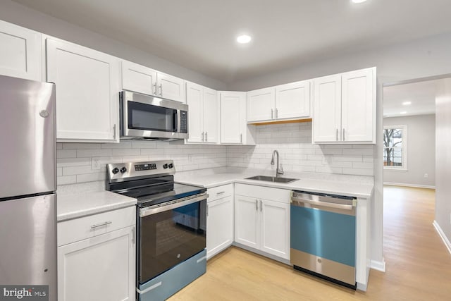 kitchen featuring sink, stainless steel appliances, and white cabinets