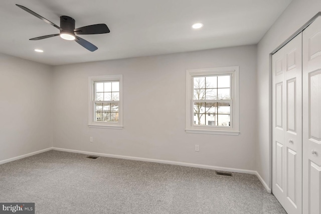 unfurnished bedroom featuring ceiling fan, carpet flooring, and a closet