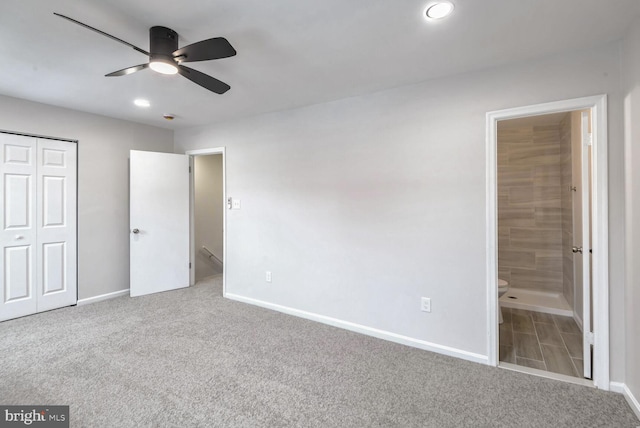 unfurnished bedroom with ensuite bathroom, carpet floors, ceiling fan, and a closet