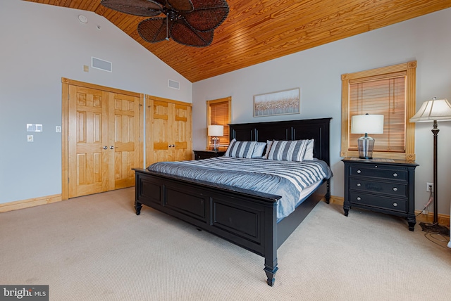 carpeted bedroom with wood ceiling and high vaulted ceiling