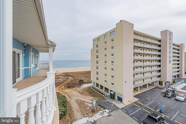 view of property with a water view and a view of the beach