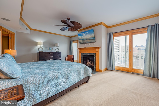 carpeted bedroom featuring ornamental molding, access to exterior, and a high end fireplace