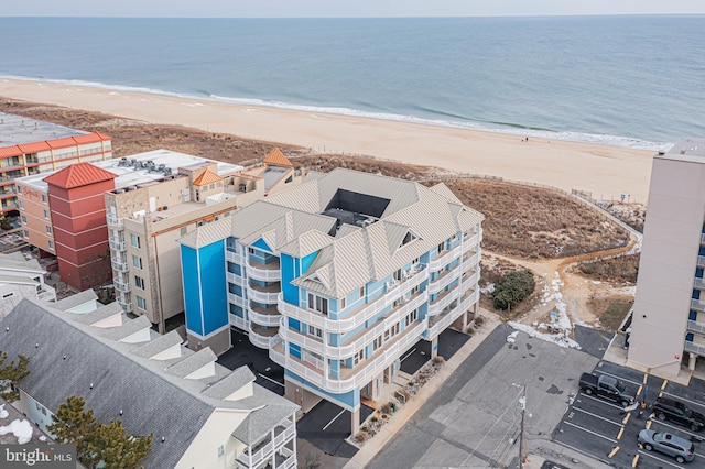 birds eye view of property with a view of the beach and a water view