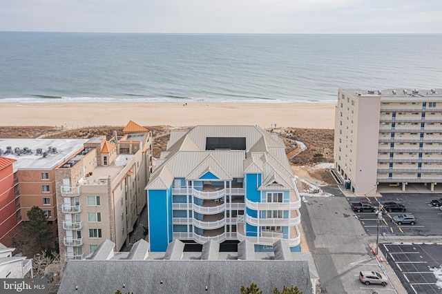 bird's eye view featuring a view of the beach and a water view