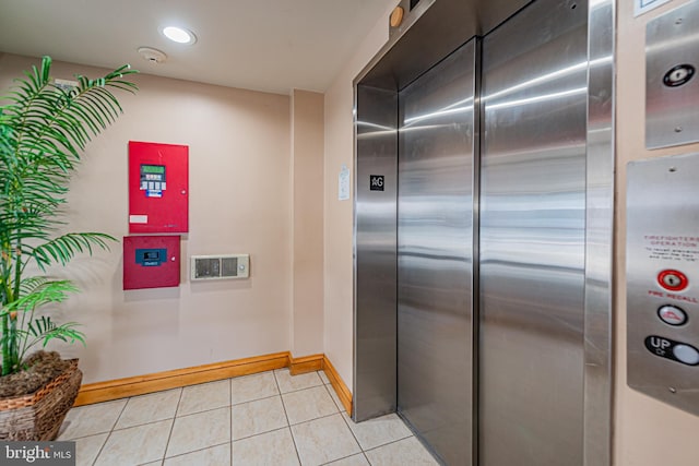 kitchen featuring light tile patterned floors and elevator