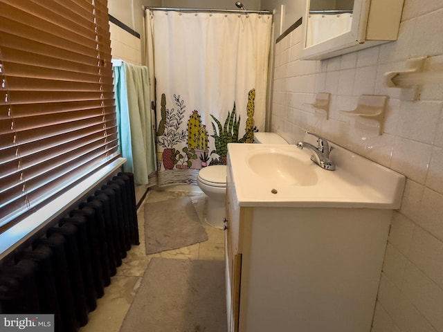 full bathroom featuring tile walls, radiator, vanity, and toilet