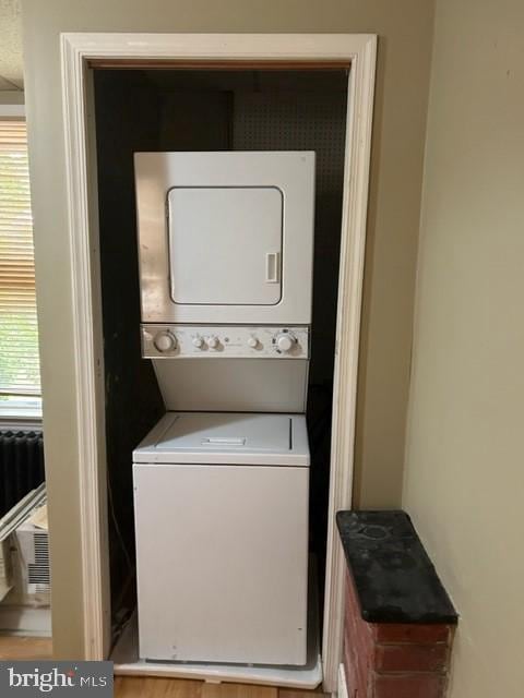 washroom with laundry area and stacked washer / dryer