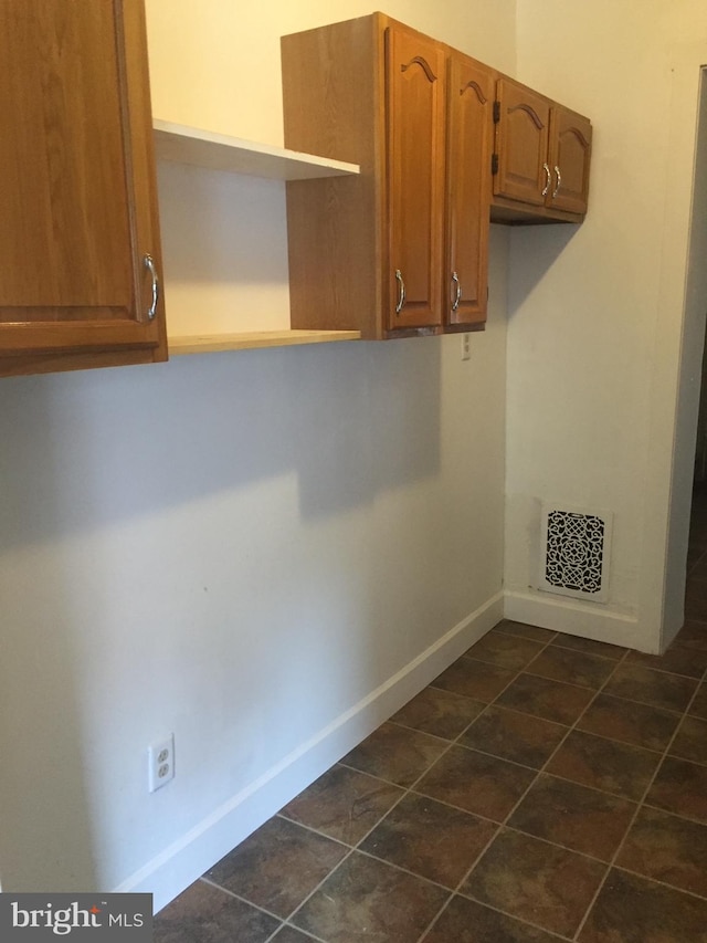 washroom with dark tile patterned flooring