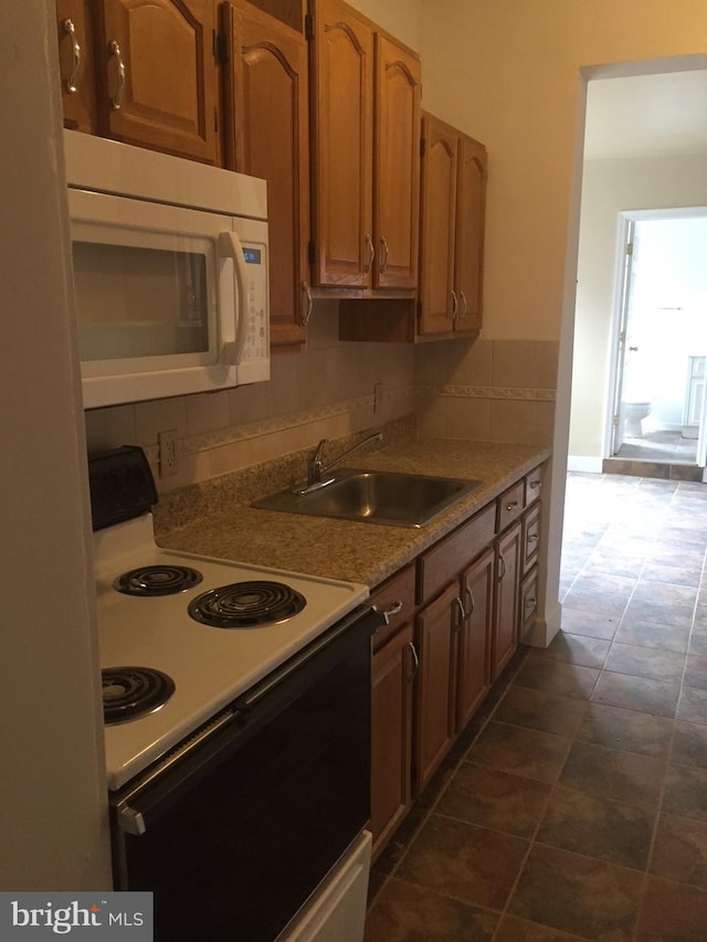 kitchen featuring dark tile patterned floors, sink, and electric range