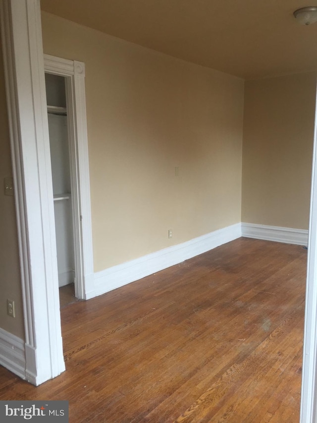 unfurnished bedroom featuring hardwood / wood-style flooring and a closet